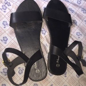 Black buckle up sandals.